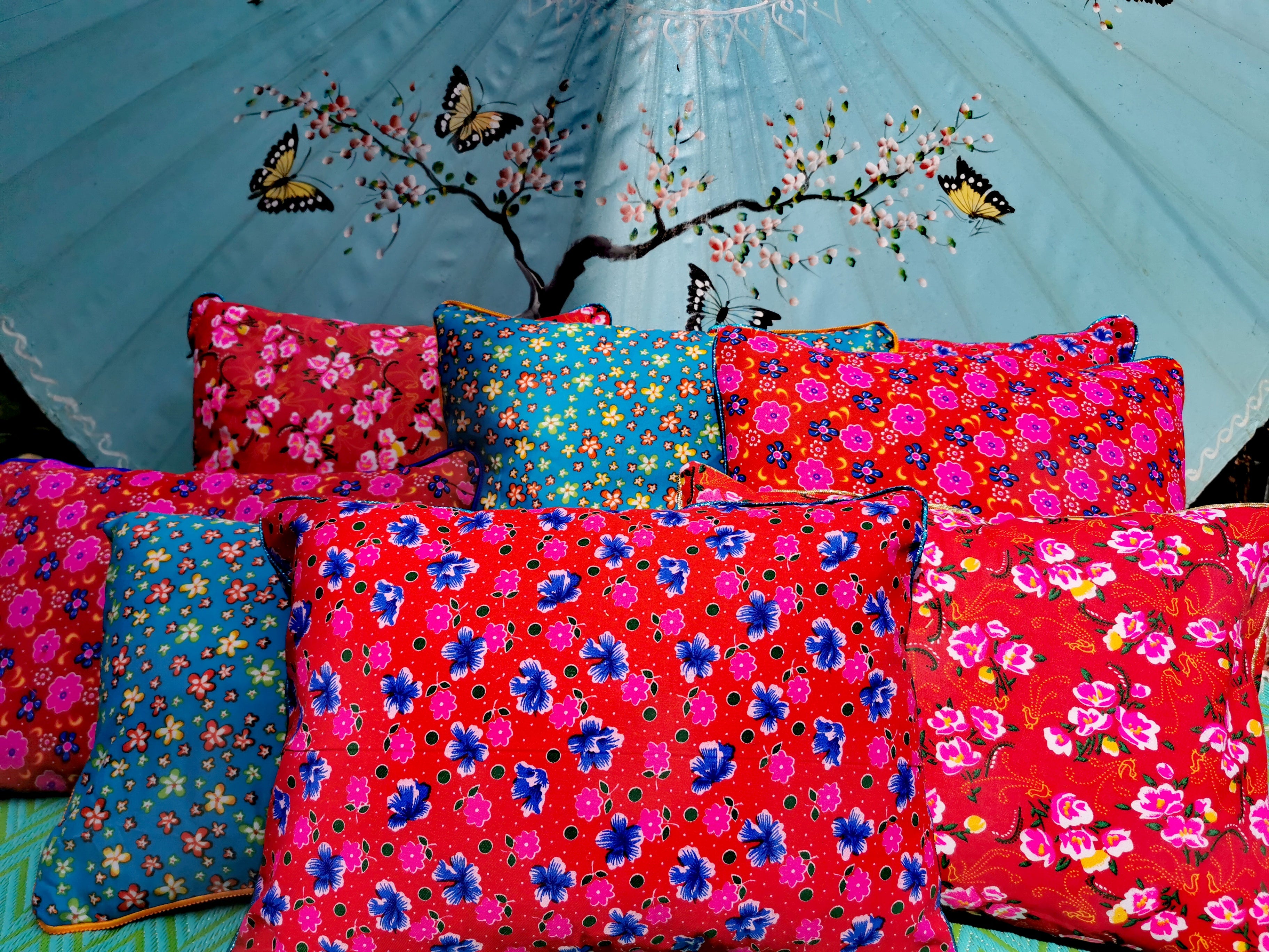 Bright and lovely folky floral fabrics used by nomadic peoples all over South and Central Asia, We love these so much that we have made them into gorgeous cushions in two sizes to mix and match on benches and sofas.

All edged with a mix of different bright or metallic piping

Mix of cotton and polycotton fabrics

