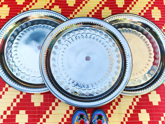 Stainless steel trays, great for recreating your Indian adventures!,this tray is large ( nearly 60 cm ) so can be used as a garden table top,or a massive platter to display food .

All are hand hammered with a similar rustic design ,made on the street,not in a factory, so vary slightly.

59cm diameter

Stainless steel

