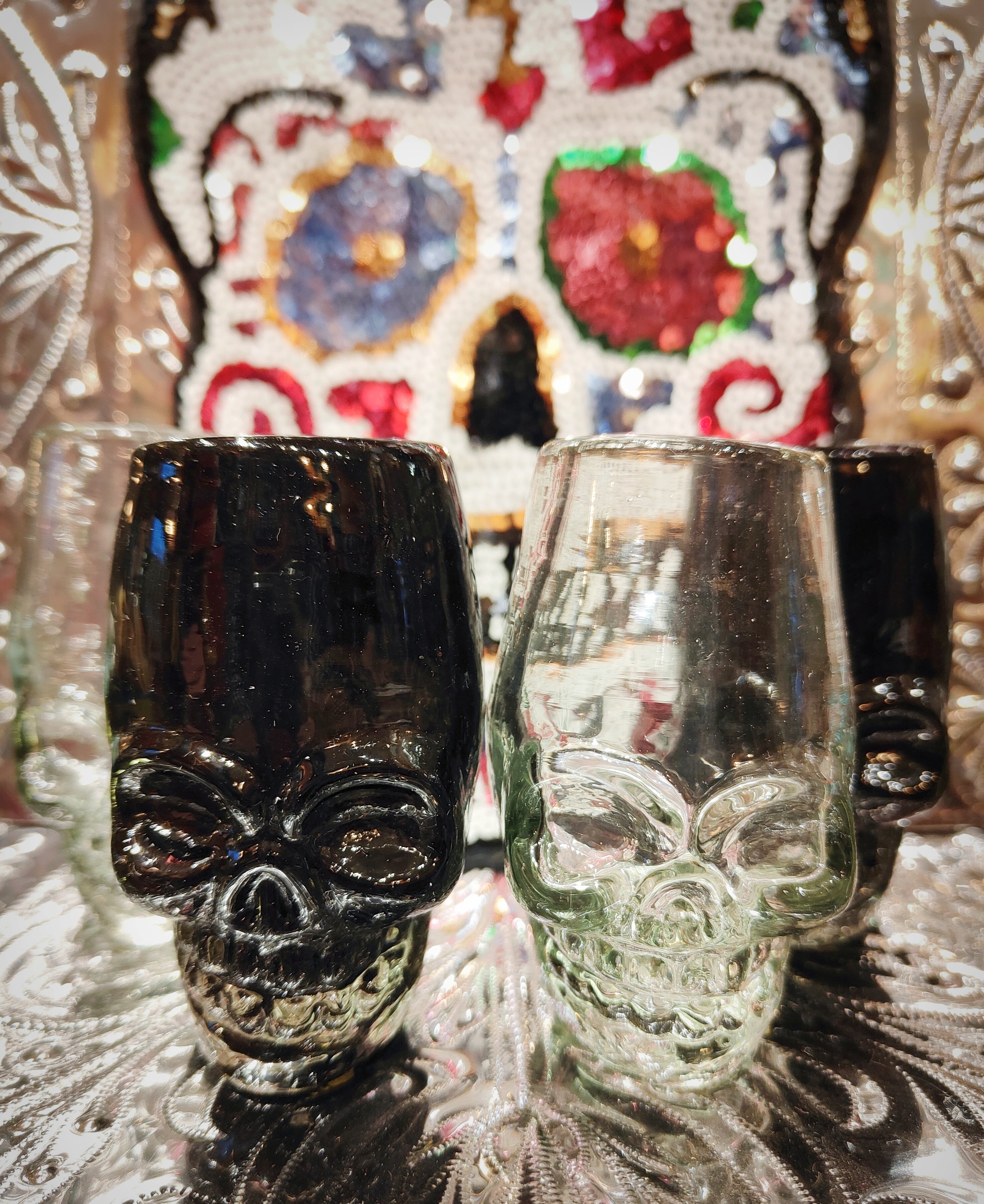 Dastardly Day of the Dead hand blown shot glasses in black or clear recycled glass. Handmade in Mexico these are a fabulous gift and even make super cute posy holders!!

Made in Mexico 

Recycled glass

Dimensions vary as these are handmade but around 9cm x 5cm x 5cm

