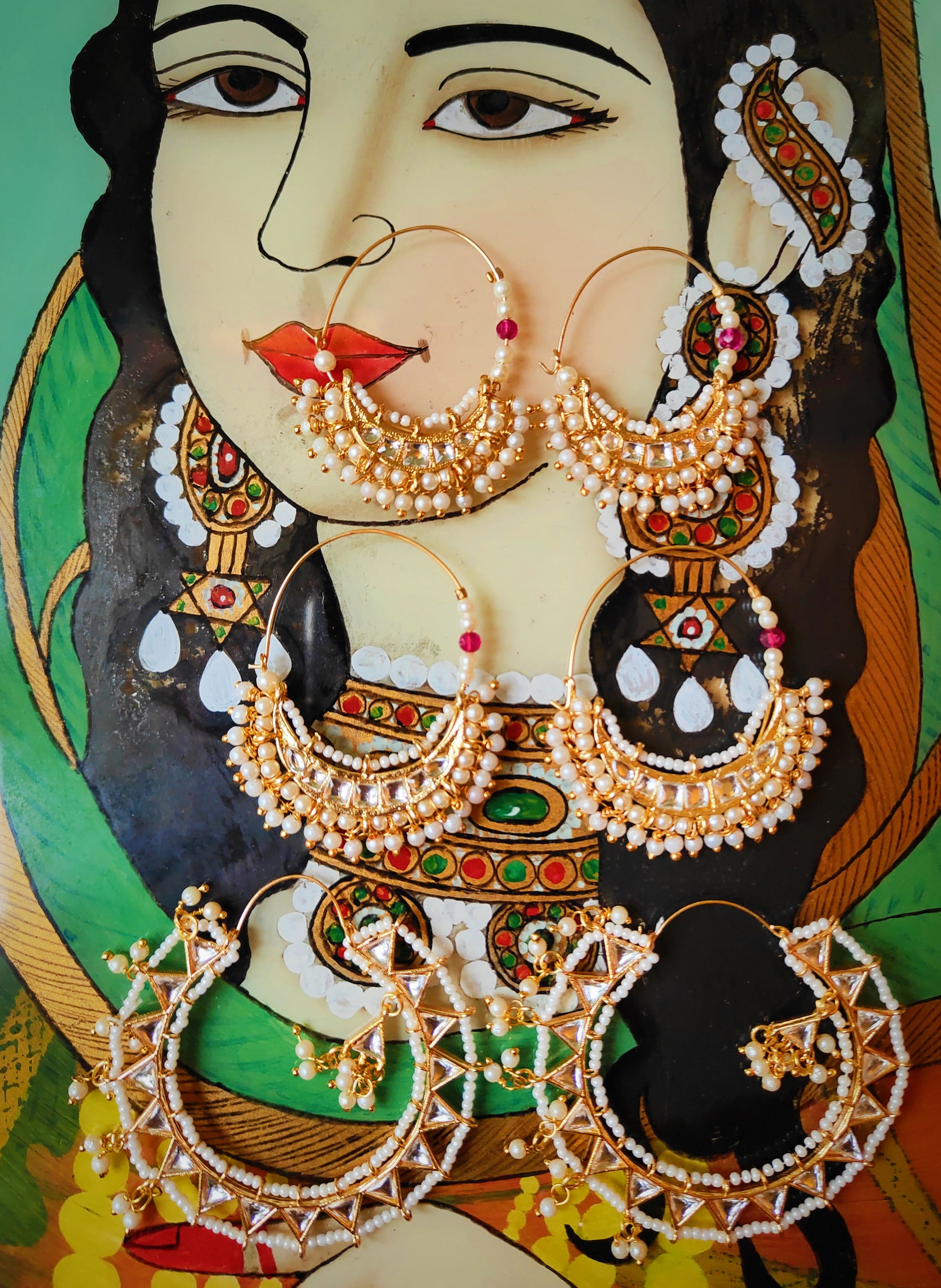 Super fine traditional Rajasthani hoops intricately handmade with gold plated brass wire,glass cabochons and tiniest glass pearls.

Traditionally made as nose rings, these are slightly assymetric as earrings,one to be put through from the back of the ear,one from the front.

Small 5 x 4cm

Medium 6 x 5cm

Large 7 x 7cm


