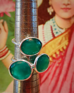 Rough cut faceted green onyx . This semi precious stone has striking bright emerald green tone. We source stones directly, choosing every one to be made into rings in India, such a juicy job!

These are made by hand from 925 silver and sit high on the hand so look fabulous stacked with plain bands.

