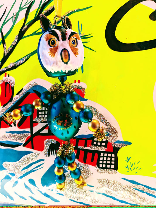 Handcrafted Christmas Owl Decoration by Nathalie Lété. This fantastic hand blown glass Owl ornament is the perfect addition for your Christmas tree or festive holiday display.  Hand blown/painted glass decoration with ribbon  Size 17 x 8 cm  Fragile, handle with care